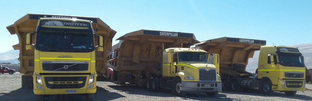 Tres camiones de Logística Inversol con tolvas de camión minero cargadas sobre camas bajas